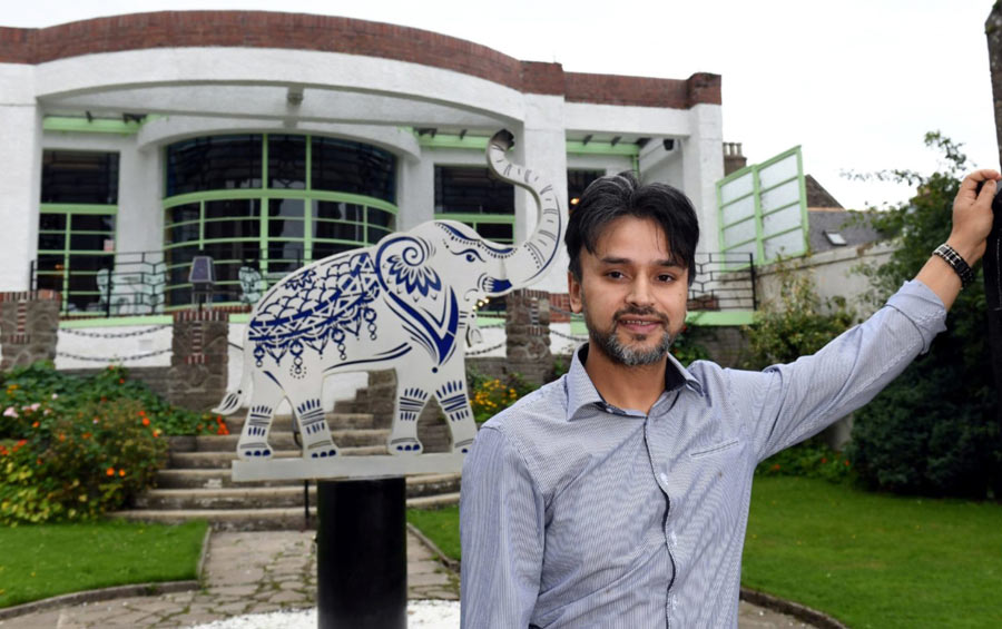 Raj outside the restaurant